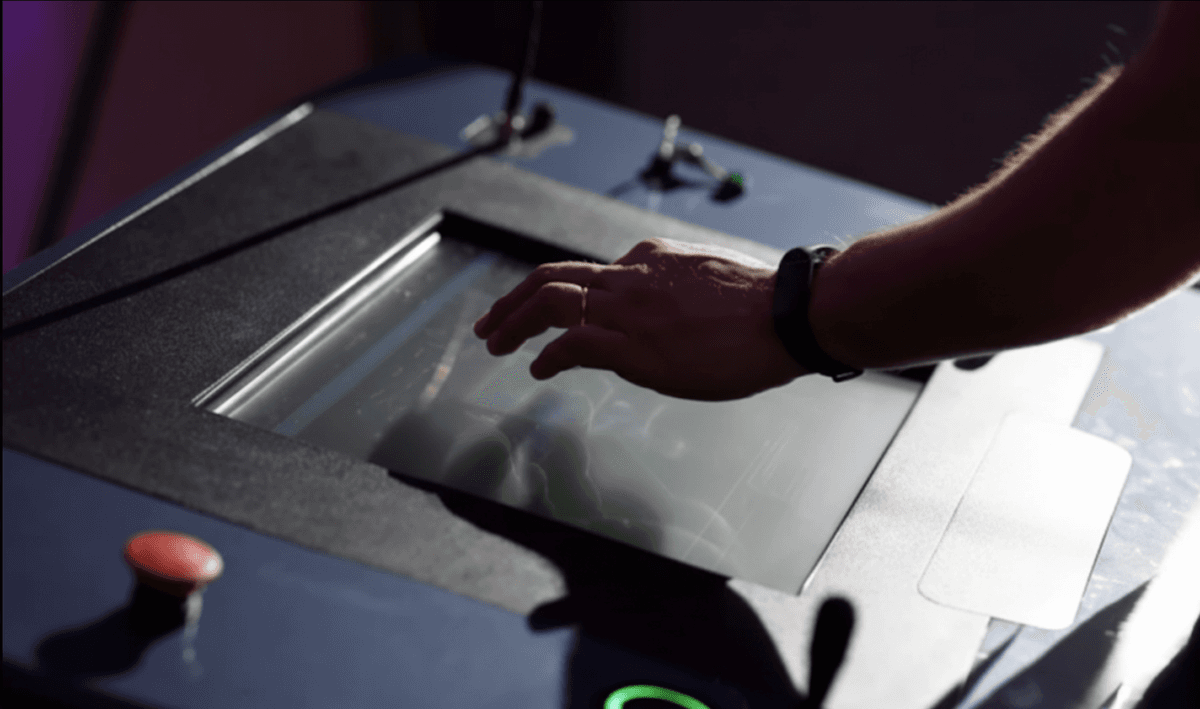 Operator using industrial HMI touchscreen interface for process control